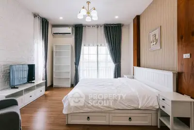 Spacious bedroom with modern decor and natural light