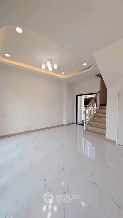 Spacious modern living room with elegant ceiling lights and marble flooring