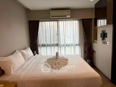 Elegant bedroom with large bed and city view, featuring modern decor and natural light.