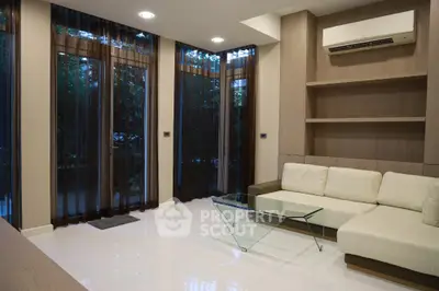 Modern living room with sleek design, large windows, and elegant furniture