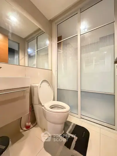Modern bathroom with sleek design and frosted glass doors