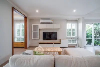 Spacious living room with modern decor and large windows for natural light