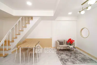 Modern living room with stylish staircase and cozy seating area