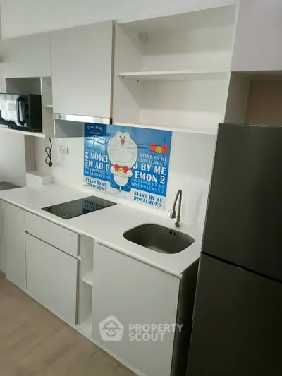 Modern kitchen with sleek appliances and open shelving, perfect for contemporary living.