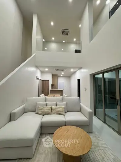 Spacious modern living room with high ceilings and elegant decor
