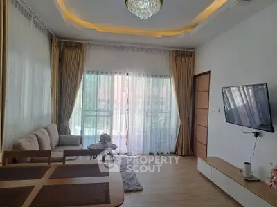 Elegant living room with modern decor, large windows, and stylish furniture, perfect for relaxation and entertainment.