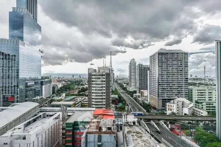 Stunning cityscape view showcasing modern skyscrapers and urban skyline under dramatic cloudy skies.