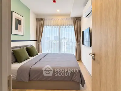 Modern bedroom with large window and stylish decor in urban apartment