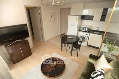 Modern living room with open kitchen, featuring stylish furniture and appliances, ideal for urban living.