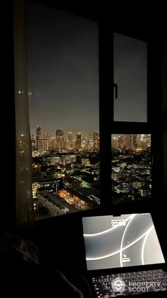 Stunning city skyline view from modern apartment window at night