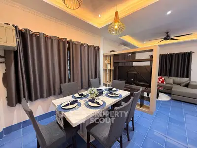 Modern dining and living area with stylish decor and blue tiled flooring.