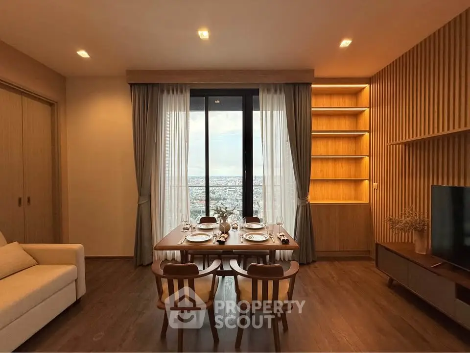 Elegant living room with dining area and city view, featuring warm wooden accents and modern furnishings.