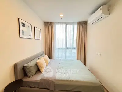 Modern bedroom with stylish decor and large window offering city view.