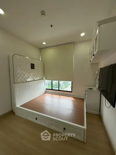 Modern bedroom with built-in storage and large window view