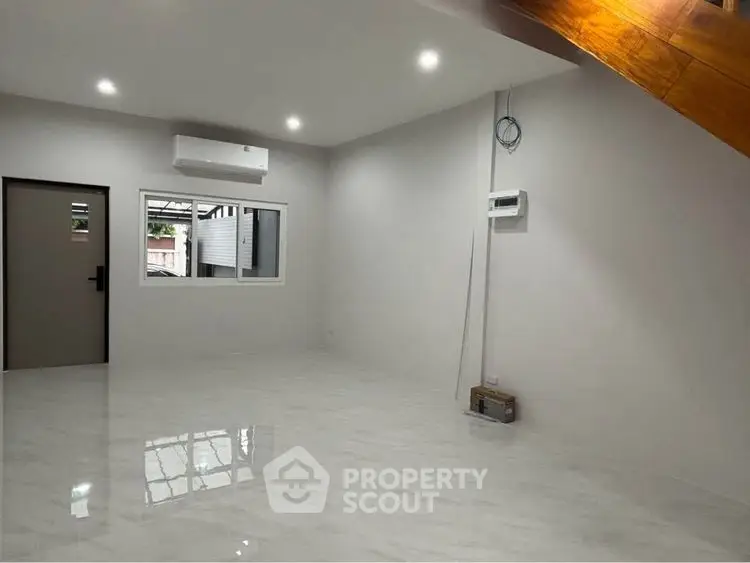 Spacious modern living room with sleek flooring and air conditioning