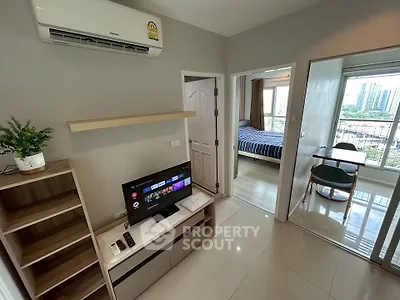 Modern apartment interior with living room, bedroom, and dining area, featuring sleek design and city view.