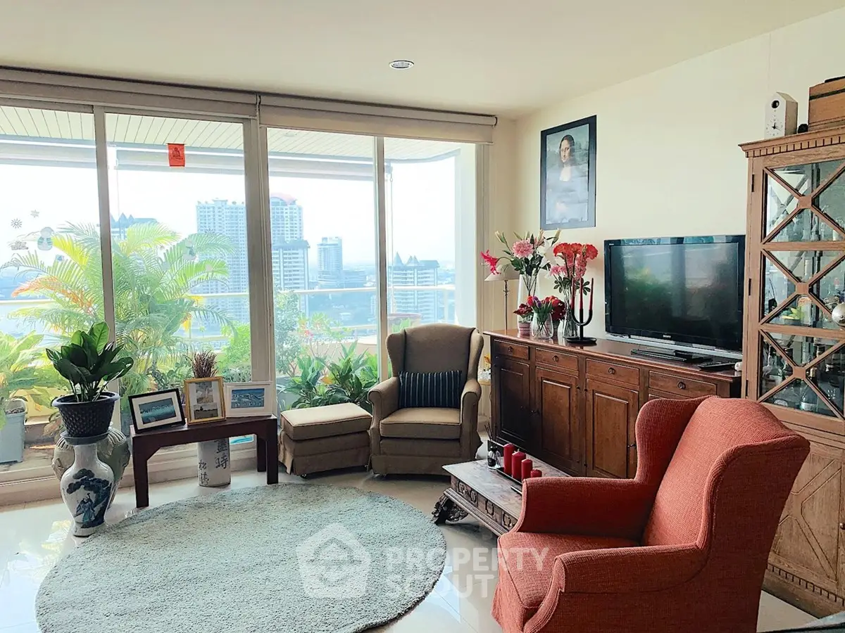 Spacious living room with city view, elegant furniture, and large windows for natural light.