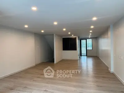 Spacious modern living room with wooden flooring and recessed lighting