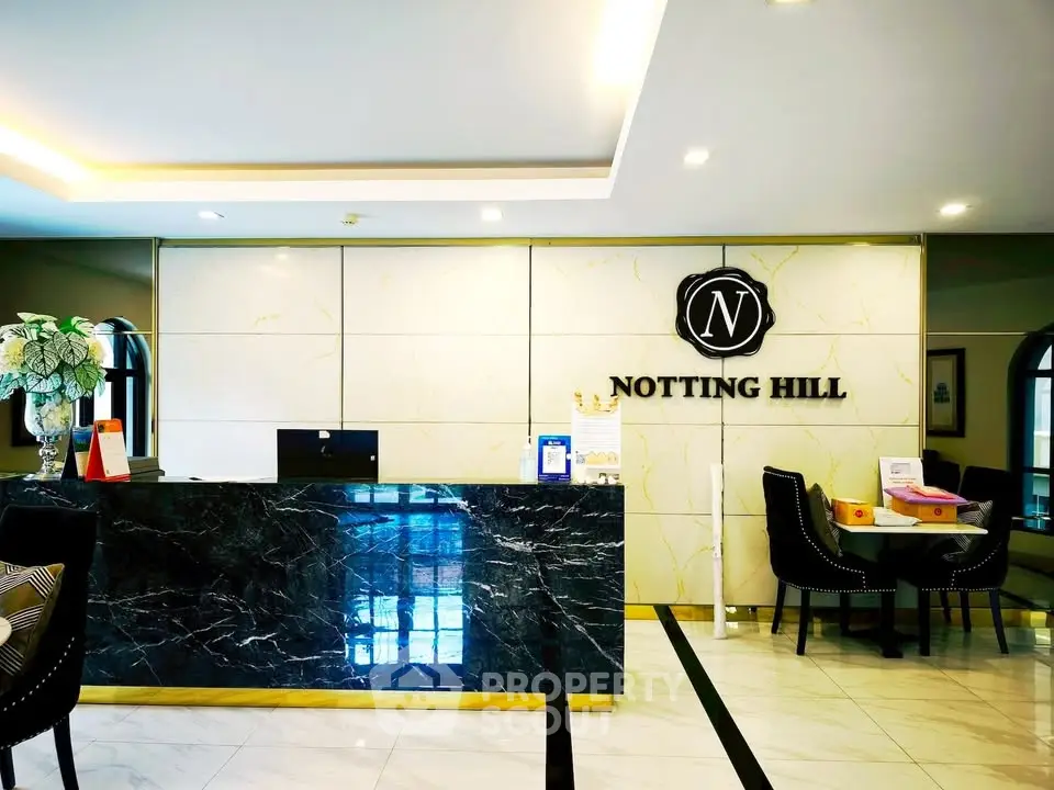 Luxurious lobby area with elegant marble reception at Notting Hill residence.