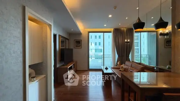 Modern living room with elegant decor and large windows offering natural light and city views.