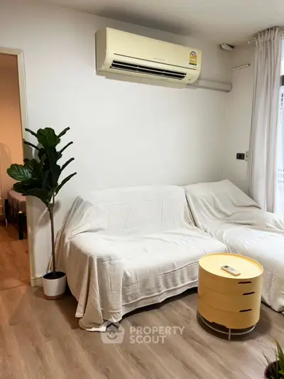 Cozy living room with air conditioning and modern decor, perfect for relaxation.