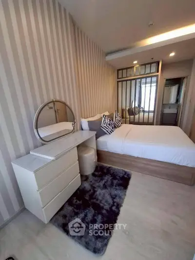 Modern bedroom with stylish decor and cozy ambiance in a contemporary apartment.