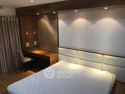 Luxurious bedroom with elegant lighting and modern furnishings in a stylish apartment.