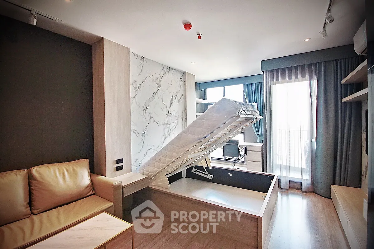 Modern studio apartment with multifunctional furniture and balcony view
