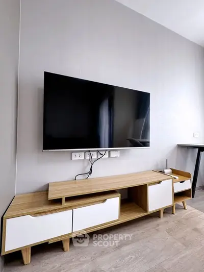 Modern living room with sleek TV setup and stylish wooden console