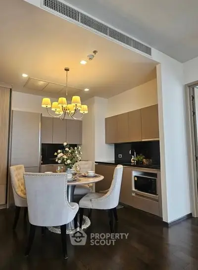 Elegant modern kitchen with dining area and stylish lighting