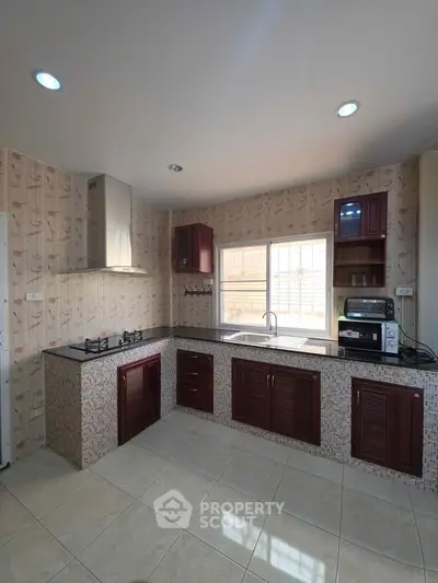 Spacious kitchen with modern appliances and elegant cabinetry, perfect for culinary enthusiasts.