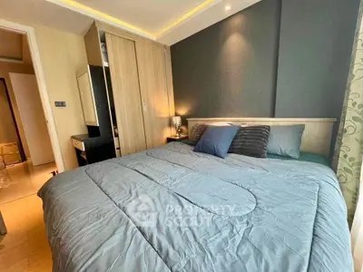 Cozy bedroom with modern design and soft lighting, featuring a comfortable bed and stylish decor.