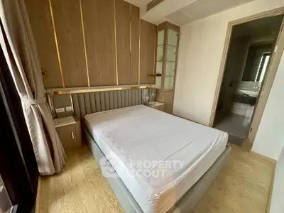 Modern bedroom with stylish wood paneling and elegant bed in a contemporary apartment.