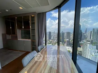 Luxurious high-rise condo with stunning city view and elegant dining area.