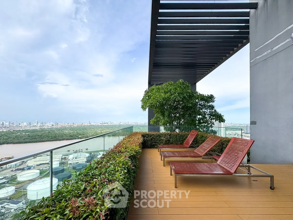 Stunning rooftop terrace with panoramic city and river views, featuring modern lounge chairs and lush greenery.