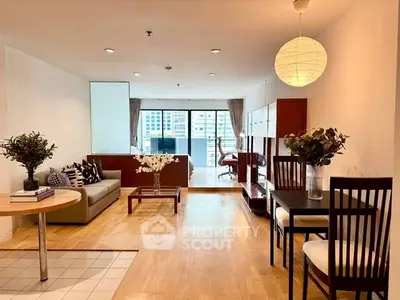 Spacious modern living room with elegant dining area and large windows offering city views.