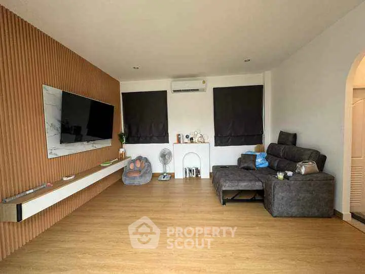 Modern living room with sleek TV setup and cozy seating area