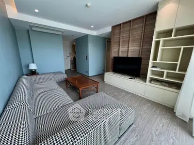 Spacious modern living room with stylish furniture and built-in entertainment center.