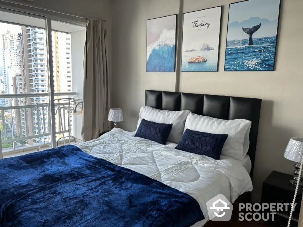 Luxurious bedroom with balcony view in high-rise apartment, featuring elegant decor and plush bedding.