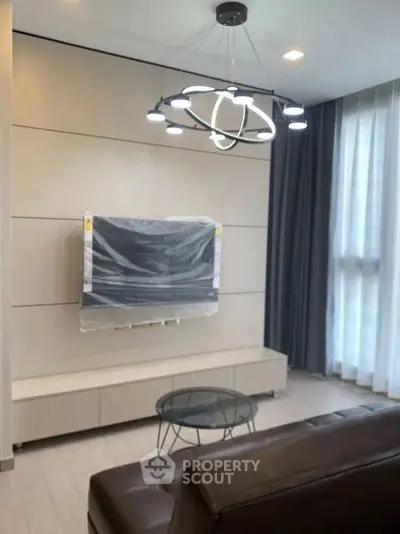 Modern living room with sleek lighting and mounted TV