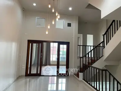 Spacious modern interior with elegant staircase and high ceilings