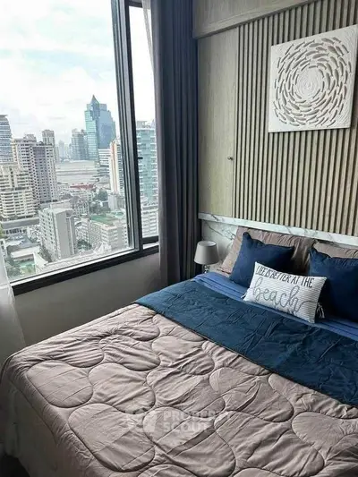 Modern bedroom with stunning city view from large window in high-rise apartment.