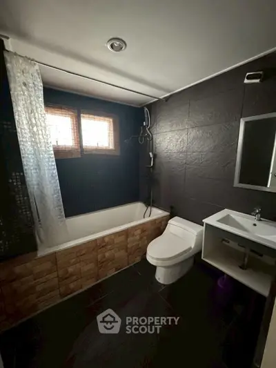 Modern bathroom with bathtub and sleek fixtures in stylish home.