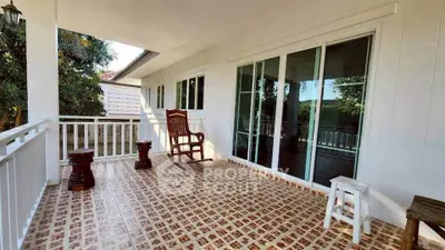 Charming balcony with tiled flooring and cozy seating, perfect for relaxation and enjoying outdoor views.