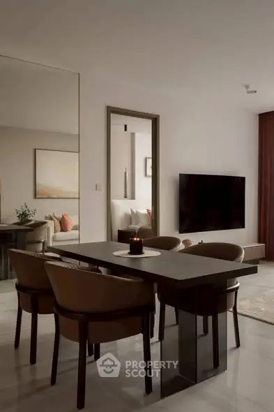 Modern dining area with sleek table and chairs, large mirror, and wall-mounted TV in stylish apartment.