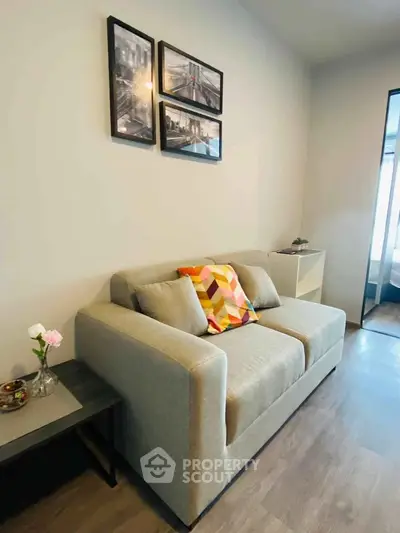 Cozy living room with modern sofa and stylish decor in a contemporary apartment.