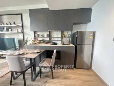 Modern kitchen with sleek cabinets and dining area in stylish apartment