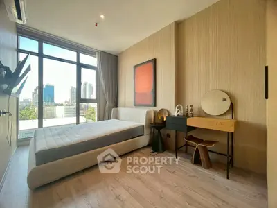 Modern bedroom with large window and city view, featuring stylish decor and natural light.