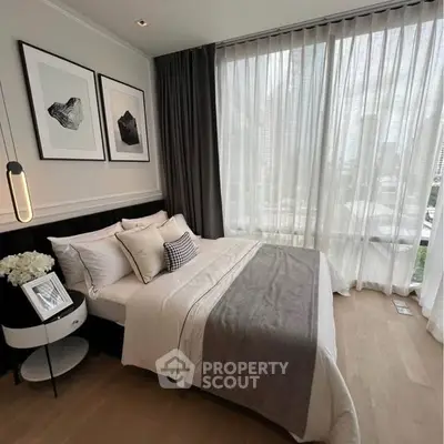 Luxurious bedroom with floor-to-ceiling windows and elegant decor in a modern apartment.