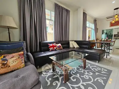 Stylish living room with modern furniture and large windows in a cozy home setting.